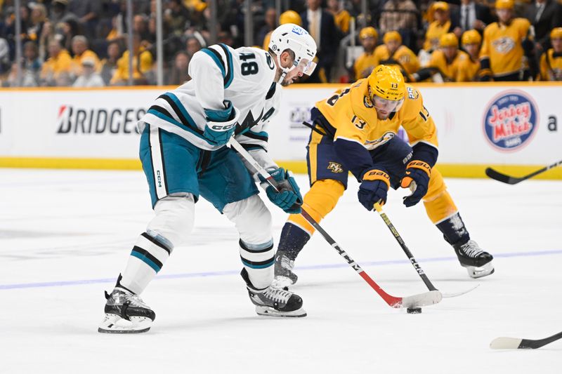 Oct 21, 2023; Nashville, Tennessee, USA; Nashville Predators center Yakov Trenin (13) pokes at the stick of San Jose Sharks right wing Filip Zadina (18) during the second period at Bridgestone Arena. Mandatory Credit: Steve Roberts-USA TODAY Sports