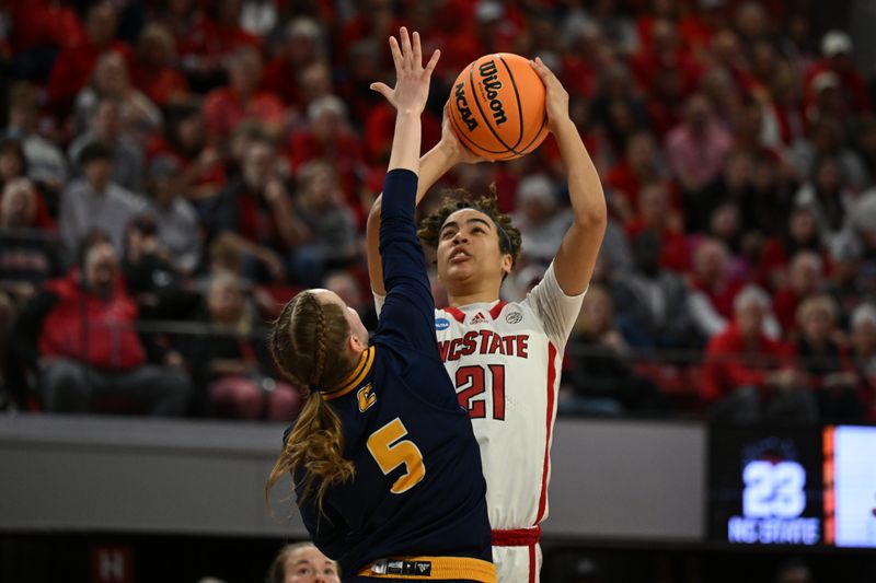 Mar 23, 2024; Raleigh, North Carolina, USA; NC State Wolfpack guard Madison Hayes (21) shoots over Chattanooga Lady Mocs guard Sigrun Olafsdottir (5) in the first round of the 2024 NCAA Women's Tournament at James T. Valvano Arena at William Neal Reynolds. Mandatory Credit: William Howard-USA TODAY Sports