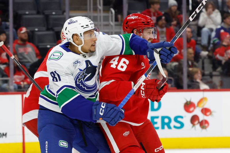 Dec 1, 2024; Detroit, Michigan, USA;  Vancouver Canucks center Dakota Joshua (81) and Detroit Red Wings defenseman Jeff Petry (46) fight for position in the third period at Little Caesars Arena. Mandatory Credit: Rick Osentoski-Imagn Images