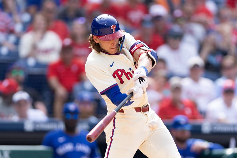 May 8, 2024; Philadelphia, Pennsylvania, USA; Philadelphia Phillies third base Alec Bohm (28) hits a single during the ninth inning against the Toronto Blue Jays at Citizens Bank Park. Mandatory Credit: Bill Streicher-USA TODAY Sports