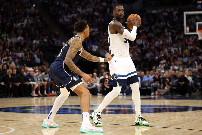 MINNEAPOLIS, MINNESOTA - OCTOBER 29: Julius Randle #30 of the Minnesota Timberwolves handles the ball against P.J. Washington #25 of the Dallas Mavericks in the third quarter at Target Center on October 29, 2024 in Minneapolis, Minnesota. The Mavericks defeated the Timberwolves 120-114. NOTE TO USER: User expressly acknowledges and agrees that, by downloading and or using this photograph, User is consenting to the terms and conditions of the Getty Images License Agreement. (Photo by David Berding/Getty Images)