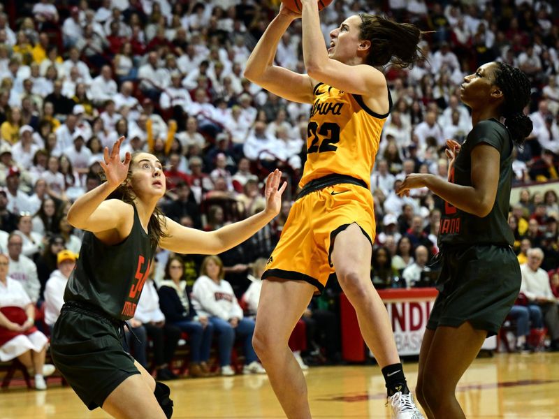 Feb 22, 2024; Bloomington, Indiana, USA; Iowa Hawkeyes guard Caitlin Clark (22) shoots the ball between Indiana Hoosiers forward Mackenzie Holmes (54), left, and guard Chloe Moore-McNeil (22), right, during the fist quarter at Simon Skjodt Assembly Hall. Mandatory Credit: Marc Lebryk-USA TODAY Sports