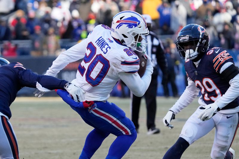 Buffalo Bills running back Nyheim Hines, center, runs past Chicago Bears cornerback Kyler Gordon, left, cornerback Josh Blackwell during the second half of an NFL football game, Saturday, Dec. 24, 2022, in Chicago. The Bills won 35-13. (AP Photo/Nam Y. Huh)