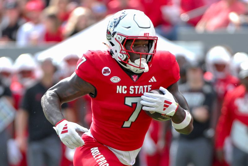 Nov 2, 2024; Raleigh, North Carolina, USA;  North Carolina State Wolfpack saftey Bishop Fitzgerald (7) runs the ball during the first quarter against Stanford Cardinals at Carter-Finley Stadium. Mandatory Credit: Zachary Taft-Imagn Images