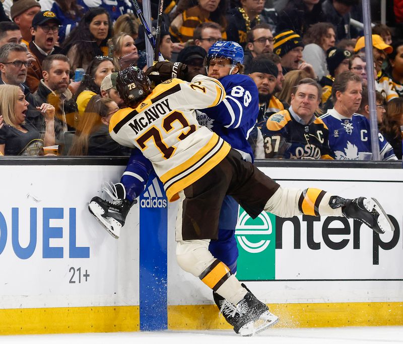 Mar 7, 2024; Boston, Massachusetts, USA; Boston Bruins defenseman Charlie McAvoy (73) checks Toronto Maple Leafs right wing William Nylander (88) during the second period at TD Garden. Mandatory Credit: Winslow Townson-USA TODAY Sports