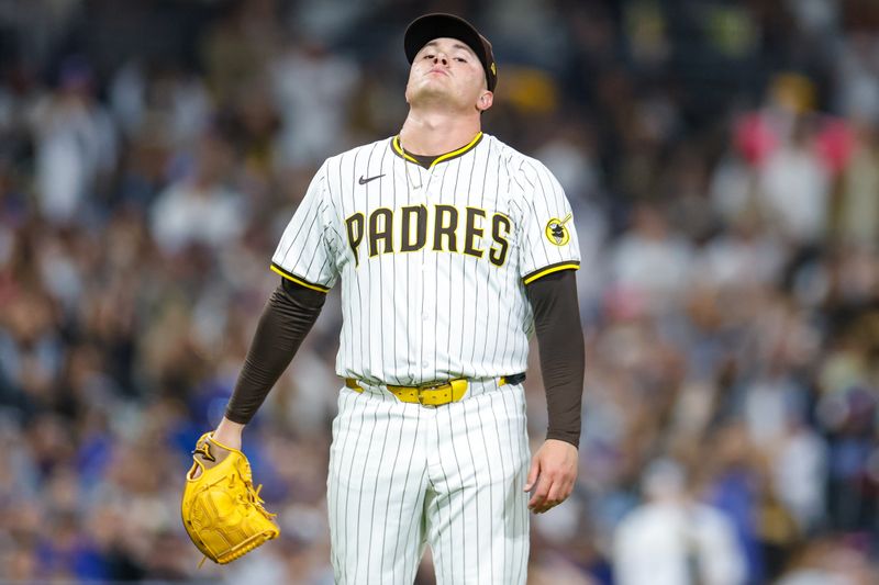 Jun 9, 2025; San Diego, California, USA; San Diego Padres relief pitcher Adrian Morejon (50) reacts after a throwing error during the eighth inning against the Los Angeles Dodgers at Petco Park. Mandatory Credit: David Frerker-Imagn Images