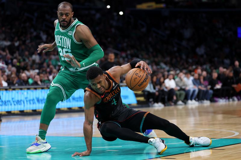 WASHINGTON, DC - MARCH 17: Jared Butler #4 of the Washington Wizards and Xavier Tillman #26 of the Boston Celtics battle for a loose ball during the first half at Capital One Arena on March 17, 2024 in Washington, DC. NOTE TO USER: User expressly acknowledges and agrees that, by downloading and or using this photograph, User is consenting to the terms and conditions of the Getty Images License Agreement.  (Photo by Patrick Smith/Getty Images)