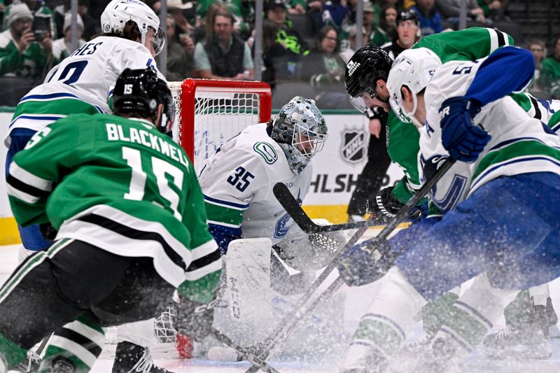 Jan 31, 2025; Dallas, Texas, USA; Vancouver Canucks goaltender Thatcher Demko (35) stops a shot by Dallas Stars defenseman Brendan Smith (2) during the second period at the American Airlines Center. Mandatory Credit: Jerome Miron-Imagn Images
