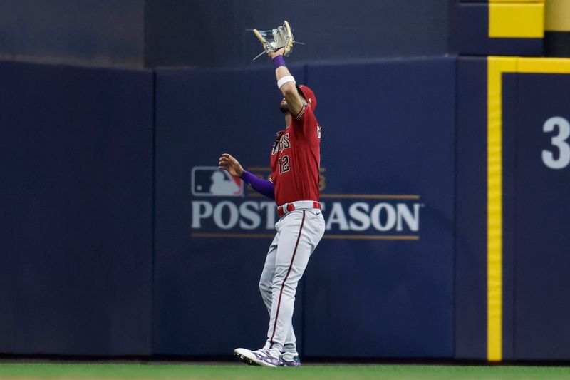 Oct 4, 2023; Milwaukee, Wisconsin, USA; Arizona Diamondbacks left fielder Lourdes Gurriel Jr. (12) makes a catch against Milwaukee Brewers left fielder Christian Yelich (not pictured) in the fifth inning during game two of the Wildcard series for the 2023 MLB playoffs at American Family Field. Mandatory Credit: Kamil Krzaczynski-USA TODAY Sports