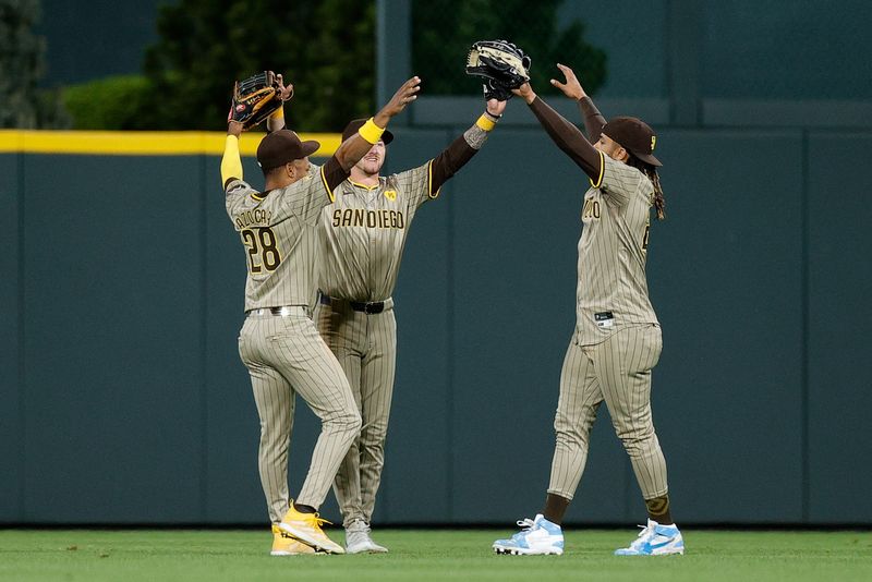 Apr 22, 2024; Denver, Colorado, USA; San Diego Padres left fielder Jose Azocar (28) and center fielder Jackson Merrill (3) and right fielder Fernando Tatis Jr. (23) celebrate in the outfield after the game against the Colorado Rockies at Coors Field. Mandatory Credit: Isaiah J. Downing-USA TODAY Sports