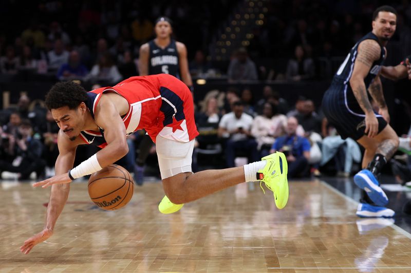 WASHINGTON, DC - MARCH 06: Jordan Poole #13 of the Washington Wizards controls the ball as he falls to the court against the Orlando Magic during the first half at Capital One Arena on March 06, 2024 in Washington, DC. NOTE TO USER: User expressly acknowledges and agrees that, by downloading and or using this photograph, User is consenting to the terms and conditions of the Getty Images License Agreement. (Photo by Patrick Smith/Getty Images)