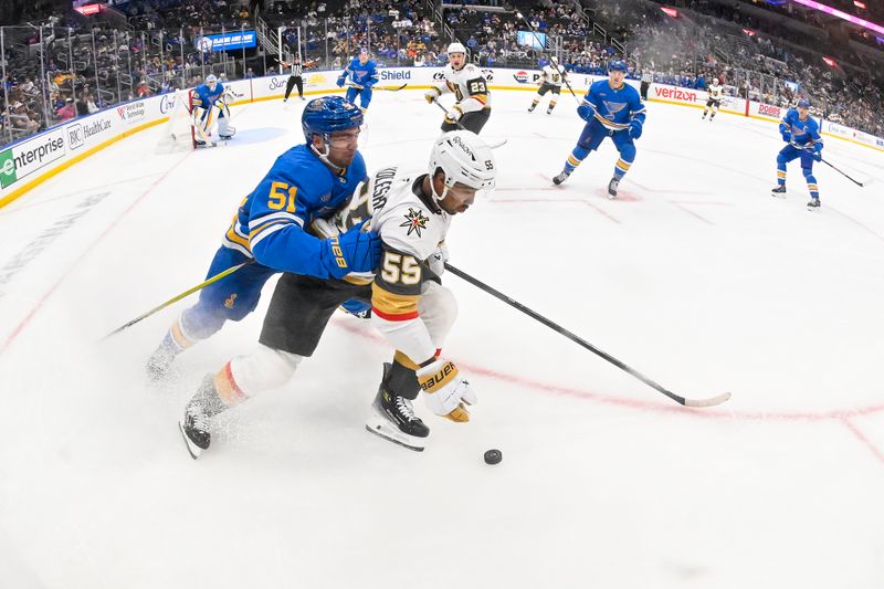 Nov 15, 2025; St. Louis, Missouri, USA; St. Louis Blues defenseman Matthew Kessel (51) defends against Vegas Golden Knights right wing Keegan Kolesar (55) during the third period at Enterprise Center. Mandatory Credit: Jeff Curry-Imagn Images