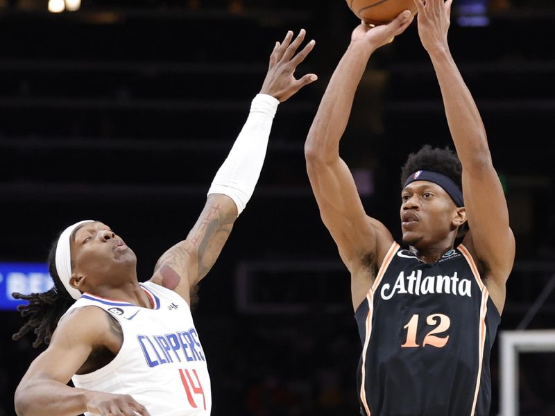 ATLANTA, GA - JANUARY 28: De'Andre Hunter #12 of the Atlanta Hawks takes a sht over Terance Mann #14 of the LA Clippers during the first half at State Farm Arena on January 28, 2023 in Atlanta, Georgia. NOTE TO USER: User expressly acknowledges and agrees that,  by downloading and or using this photograph,  User is consenting to the terms and conditions of the Getty Images License Agreement. (Photo by Alex Slitz/Getty Images)