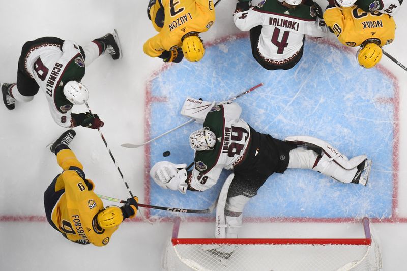 Nov 11, 2023; Nashville, Tennessee, USA; Arizona Coyotes goaltender Connor Ingram (39) makes a save during the second period against Nashville Predators left wing Filip Forsberg (9) at Bridgestone Arena. Mandatory Credit: Christopher Hanewinckel-USA TODAY Sports