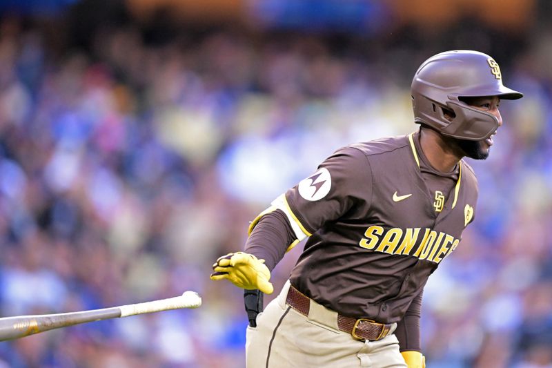 Apr 14, 2024; Los Angeles, California, USA;  San Diego Padres outfielder Jurickson Profar (10) runs to first on a three run double in the seventh inning against the Los Angeles Dodgers at Dodger Stadium. Mandatory Credit: Jayne Kamin-Oncea-USA TODAY Sports