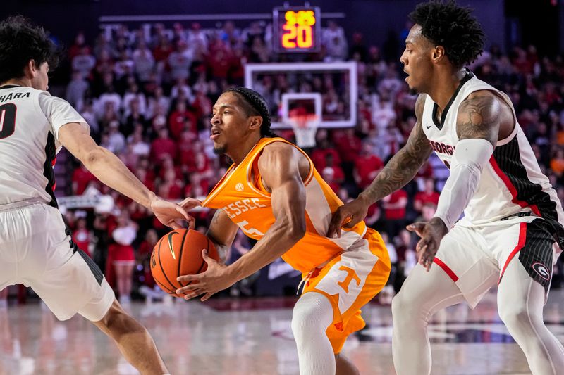 Jan 13, 2024; Athens, Georgia, USA; Tennessee Volunteers guard Zakai Zeigler (5) has his jersey pulled by Georgia Bulldogs guard RJ Sunahara (10) during the first half at Stegeman Coliseum. Mandatory Credit: Dale Zanine-USA TODAY Sports