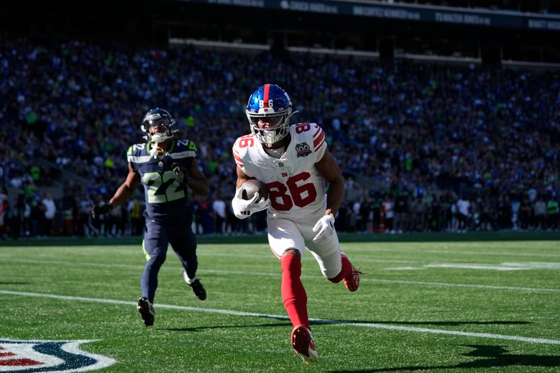 New York Giants wide receiver Darius Slayton (86) scores a 30-yard touchdown ahead of Seattle Seahawks cornerback Tre Brown (22) during the second half of an NFL football game, Sunday, Oct. 6, 2024, in Seattle. (AP Photo/Lindsey Wasson)