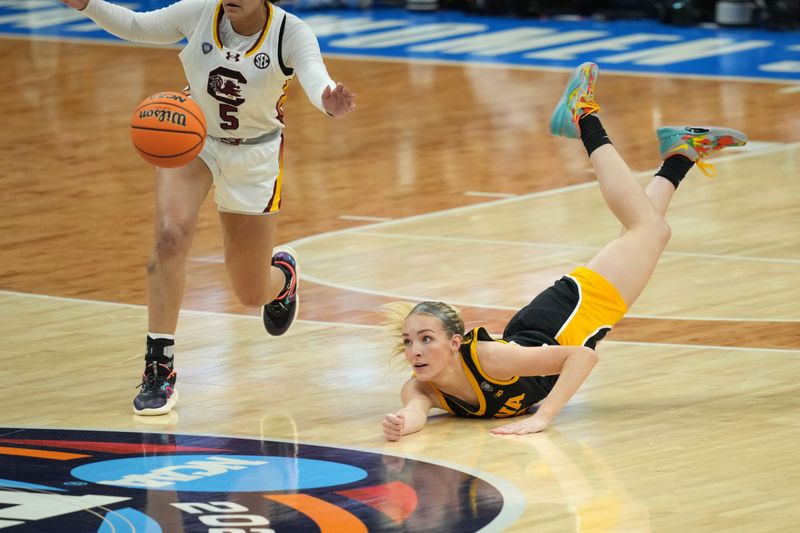 Apr 7, 2024; Cleveland, OH, USA; Iowa Hawkeyes guard Kylie Feuerbach (4) dives for a loose ball against the South Carolina Gamecocks in the finals of the Final Four of the womens 2024 NCAA Tournament at Rocket Mortgage FieldHouse. Mandatory Credit: Aaron Doster-USA TODAY Sports