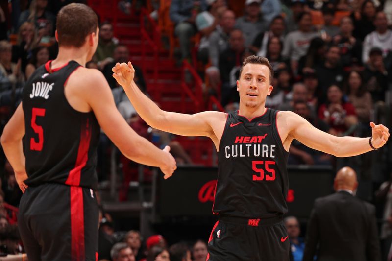 MIAMI, FL - JANUARY 14: Duncan Robinson #55 and Nikola Jovic #5  of the Miami Heat celebrate three point basket during the game against the Charlotte Hornets on January 14, 2024 at Kaseya Center in Miami, Florida. NOTE TO USER: User expressly acknowledges and agrees that, by downloading and or using this Photograph, user is consenting to the terms and conditions of the Getty Images License Agreement. Mandatory Copyright Notice: Copyright 2024 NBAE (Photo by Issac Baldizon/NBAE via Getty Images)