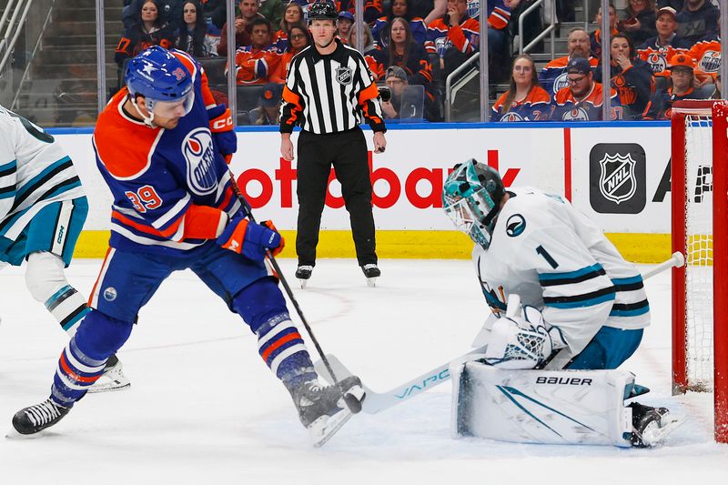 Apr 15, 2024; Edmonton, Alberta, CAN; Edmonton Oilers forward Sam Carrick (39) tries to deflect a shot past San Jose Sharks goaltender Devin Cooley (1) during the first period at Rogers Place. Mandatory Credit: Perry Nelson-USA TODAY Sports