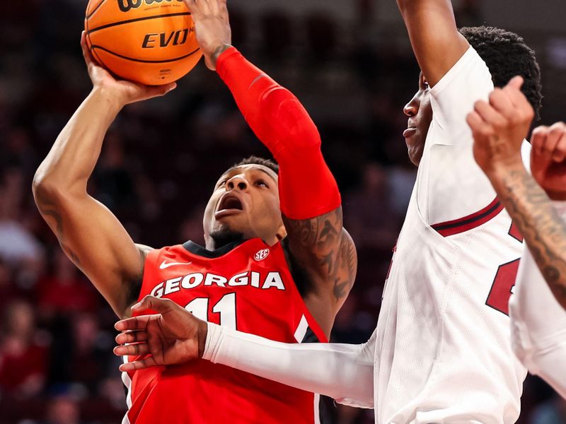 Mar 4, 2023; Columbia, South Carolina, USA; Georgia Bulldogs guard Justin Hill (11) attempts to shoot over South Carolina Gamecocks forward Gregory \