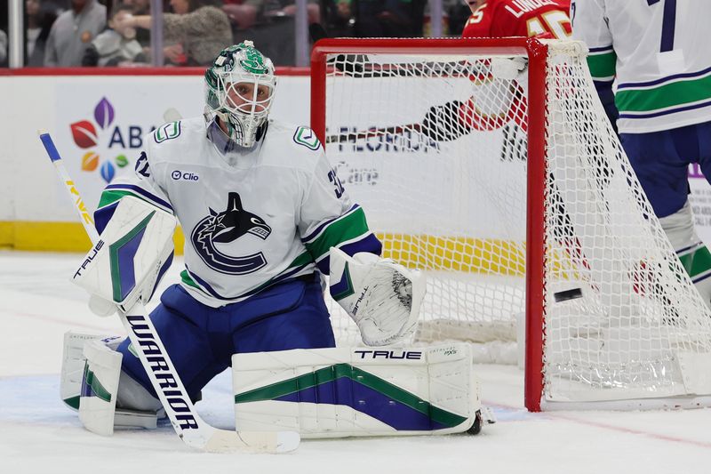 Oct 17, 2024; Sunrise, Florida, USA; Vancouver Canucks goaltender Kevin Lankinen (32) watches the puck against the Florida Panthers during the third period at Amerant Bank Arena. Mandatory Credit: Sam Navarro-Imagn Images