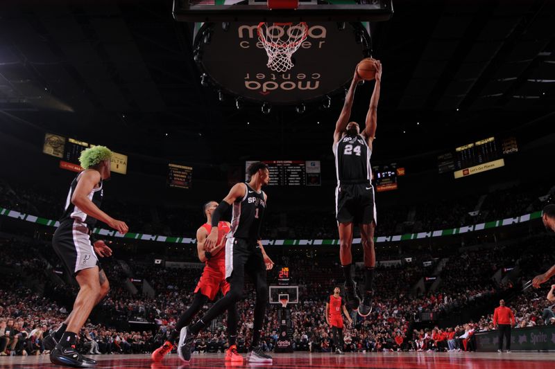 PORTLAND, OR - DECEMBER 13: Devin Vassell #24 of the San Antonio Spurs grabs the rebound during the game against the Portland Trail Blazers on December 13, 2024 at the Moda Center Arena in Portland, Oregon. NOTE TO USER: User expressly acknowledges and agrees that, by downloading and or using this photograph, user is consenting to the terms and conditions of the Getty Images License Agreement. Mandatory Copyright Notice: Copyright 2024 NBAE (Photo by Cameron Browne/NBAE via Getty Images)