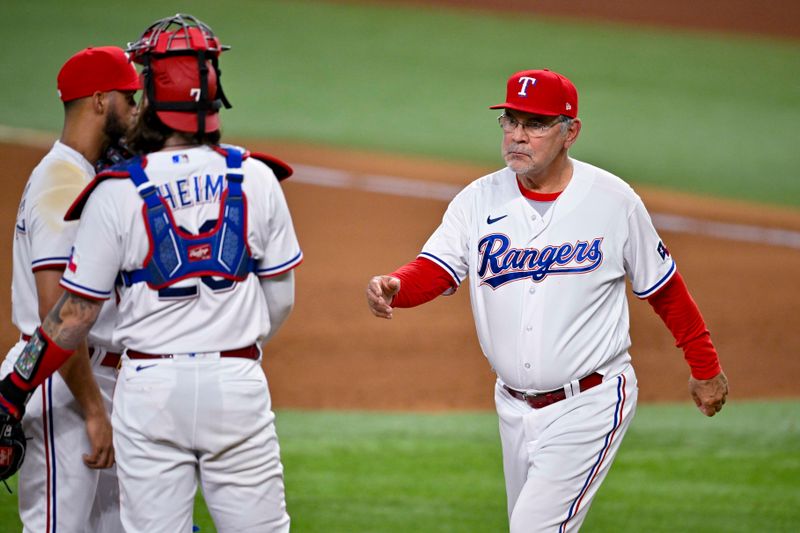 May 16, 2023; Arlington, Texas, USA; Texas Rangers manager Bruce Bochy (15) takes the ball from relief pitcher Jonathan Hernandez (72) during the eighth inning against the Atlanta Braves at Globe Life Field. Mandatory Credit: Jerome Miron-USA TODAY Sports