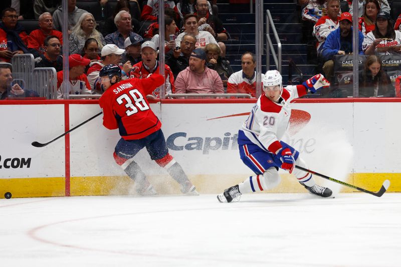 Oct 31, 2024; Washington, District of Columbia, USA; Washington Capitals defenseman Rasmus Sandin (38) controls the puck in front off Montreal Canadiens left wing Juraj Slafkovsky (20) in the second period at Capital One Arena. Mandatory Credit: Geoff Burke-Imagn Images