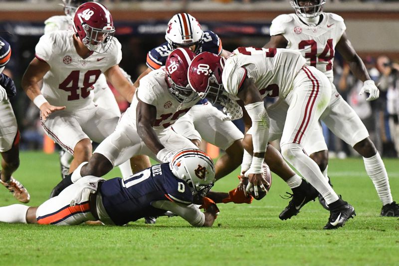 Nov 25, 2023; Auburn, Alabama, USA;  Alabama Crimson Tide linebacker Jihaad Campbell (30) recovers a muffed punt by Auburn Tigers wide receiver Koy Moore (0) at Jordan-Hare Stadium. Alabama won 27-24. Mandatory Credit: Gary Cosby Jr.-USA TODAY Sports