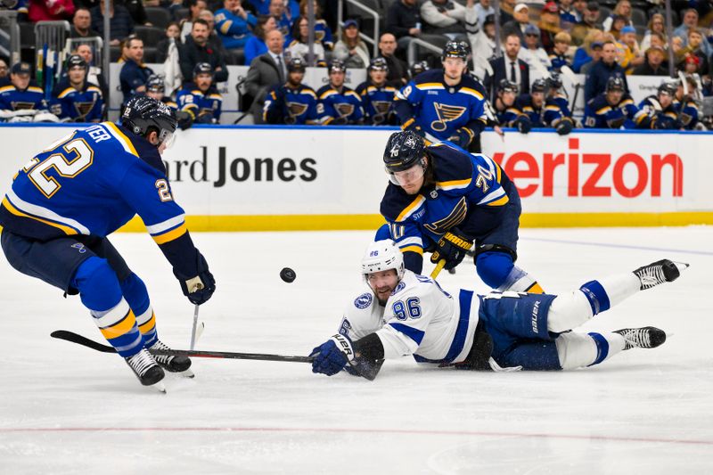 Nov 5, 2024; St. Louis, Missouri, USA;  St. Louis Blues center Oskar Sundqvist (70) and St. Louis Blues defenseman Ryan Suter (22) battle for the puck against Tampa Bay Lightning right wing Nikita Kucherov (86) during the first period at Enterprise Center. Mandatory Credit: Jeff Curry-Imagn Images