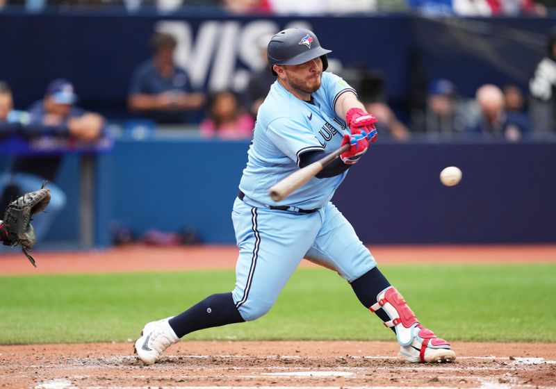 Aug 30, 2023; Toronto, Ontario, CAN; Toronto Blue Jays catcher Alejandro Kirk (30) hits a single against the Washington Nationals during the sixth inning at Rogers Centre. Mandatory Credit: Nick Turchiaro-USA TODAY Sports