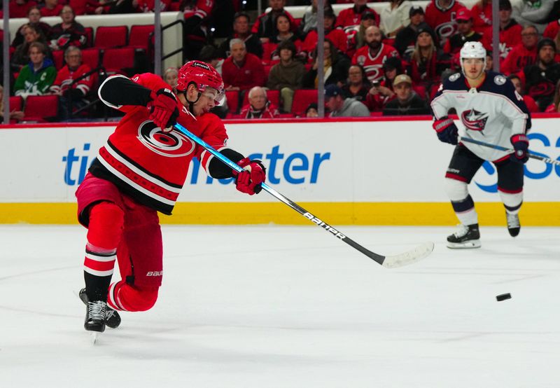 Nov 26, 2023; Raleigh, North Carolina, USA; Carolina Hurricanes center Jesperi Kotkaniemi (82) scores a goal against the Columbus Blue Jackets during the third period at PNC Arena. Mandatory Credit: James Guillory-USA TODAY Sports