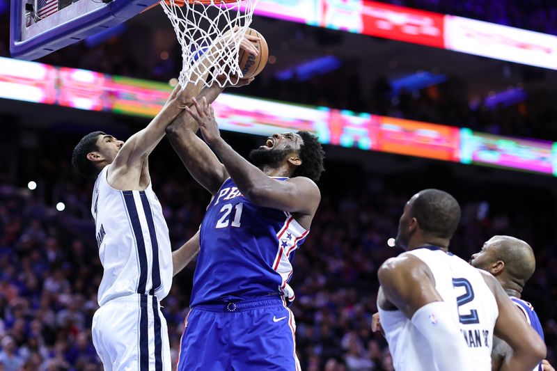 PHILADELPHIA, PENNSYLVANIA - FEBRUARY 23: Santi Aldama #7 of the Memphis Grizzlies blocks Joel Embiid #21 of the Philadelphia 76ers during the third quarter at Wells Fargo Center on February 23, 2023 in Philadelphia, Pennsylvania. NOTE TO USER: User expressly acknowledges and agrees that, by downloading and or using this photograph, User is consenting to the terms and conditions of the Getty Images License Agreement. (Photo by Tim Nwachukwu/Getty Images)