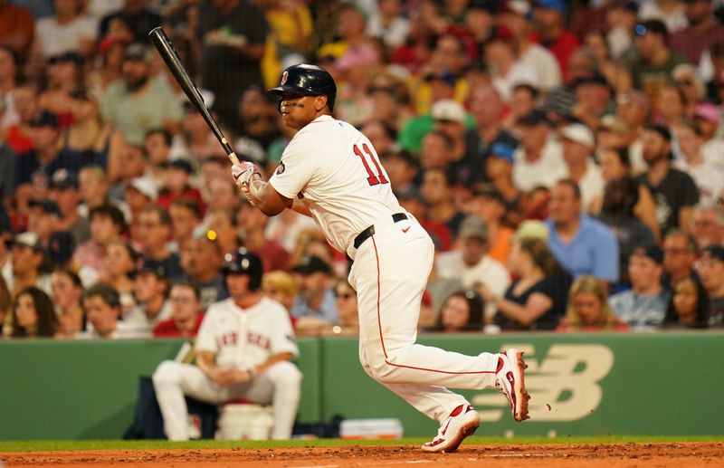 Jul 9, 2024; Boston, Massachusetts, USA; Boston Red Sox third baseman Rafael Devers (11) hits a double to drive in a run against the Oakland Athletics in the second inning at Fenway Park. Mandatory Credit: David Butler II-USA TODAY Sports