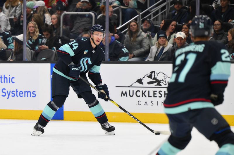 Nov 22, 2023; Seattle, Washington, USA; Seattle Kraken defenseman Jamie Oleksiak (24) looks to pass the puck against the San Jose Sharks during the second period at Climate Pledge Arena. Mandatory Credit: Steven Bisig-USA TODAY Sports