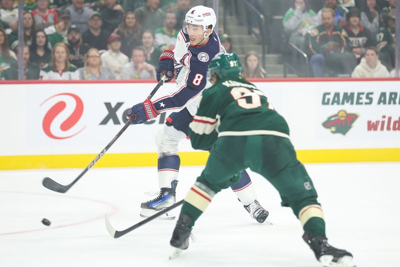 Oct 10, 2024; Saint Paul, Minnesota, USA; Columbus Blue Jackets defenseman Zach Werenski (8) shoots as Minnesota Wild left wing Kirill Kaprizov (97) defends during the first period at Xcel Energy Center. Mandatory Credit: Matt Krohn-Imagn Images