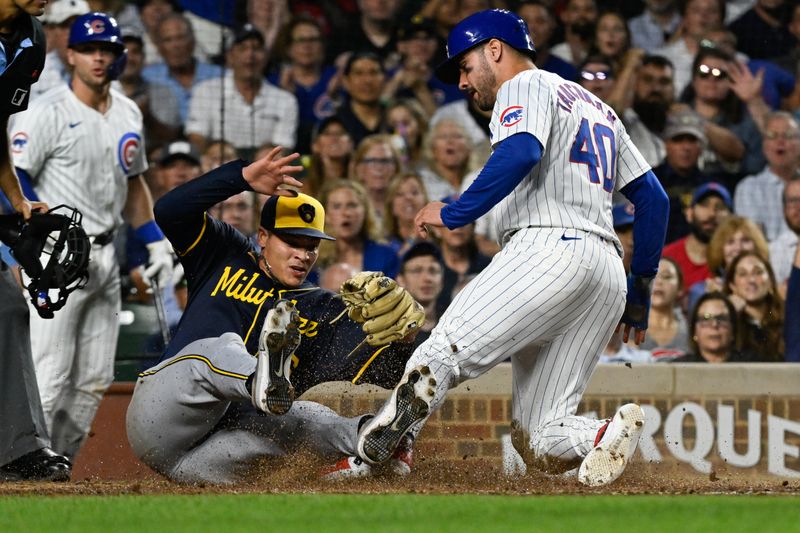 Jul 22, 2024; Chicago, Illinois, USA;  Chicago Cubs outfielder Mike Tauchman (40) scores past Milwaukee Brewers pitcher Tobias Myers (36) on a wild pitch during the fourth inning at Wrigley Field. Mandatory Credit: Matt Marton-USA TODAY Sports