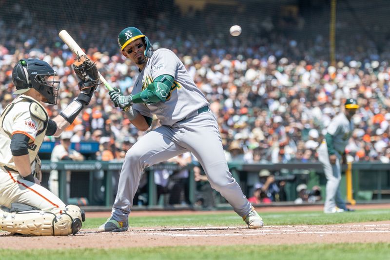 May 18, 2025; San Francisco, California, USA; Oakland Athletics catcher Jhonny Pereda (64) dodges a wild pitch during the fourth inning against the San Francisco Giants at Oracle Park. Mandatory Credit: Bob Kupbens-Imagn Images