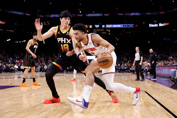 PHOENIX, ARIZONA - DECEMBER 15: Quentin Grimes #6 of the New York Knicks drives against Yuta Watanabe #18 of the Phoenix Suns during the first half at Footprint Center on December 15, 2023 in Phoenix, Arizona. NOTE TO USER: User expressly acknowledges and agrees that, by downloading and or using this photograph, User is consenting to the terms and conditions of the Getty Images License Agreement.  (Photo by Chris Coduto/Getty Images)