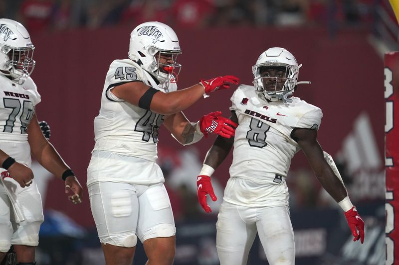 Sep 24, 2021; Fresno, California, USA; UNLV Rebels running back Charles Williams (8) is congratulated by tight end Giovanni Fauolo Sr. (45) after scoring a touchdown against the Fresno State Bulldogs in the first quarter at Bulldog Stadium. Mandatory Credit: Cary Edmondson-USA TODAY Sports