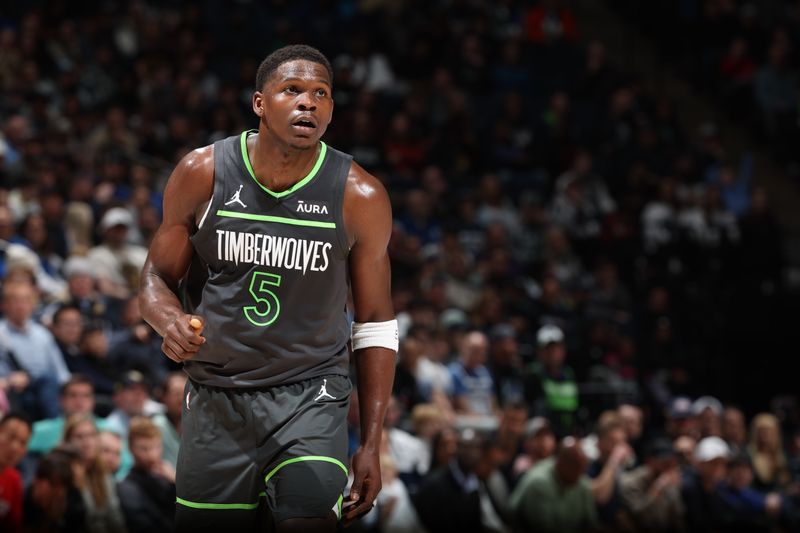 MINNEAPOLIS, MN -  MARCH 24: Anthony Edwards #5 of the Minnesota Timberwolves looks on during the game against the Golden State Warriors on March 24, 2024 at Target Center in Minneapolis, Minnesota. NOTE TO USER: User expressly acknowledges and agrees that, by downloading and or using this Photograph, user is consenting to the terms and conditions of the Getty Images License Agreement. Mandatory Copyright Notice: Copyright 2024 NBAE (Photo by David Sherman/NBAE via Getty Images)