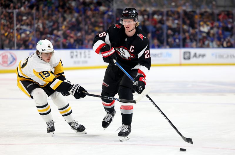 Jan 17, 2025; Buffalo, New York, USA;  Buffalo Sabres defenseman Rasmus Dahlin (26) makes a pass as Pittsburgh Penguins center Cody Glass (19) defends during the second period at KeyBank Center. Mandatory Credit: Timothy T. Ludwig-Imagn Images