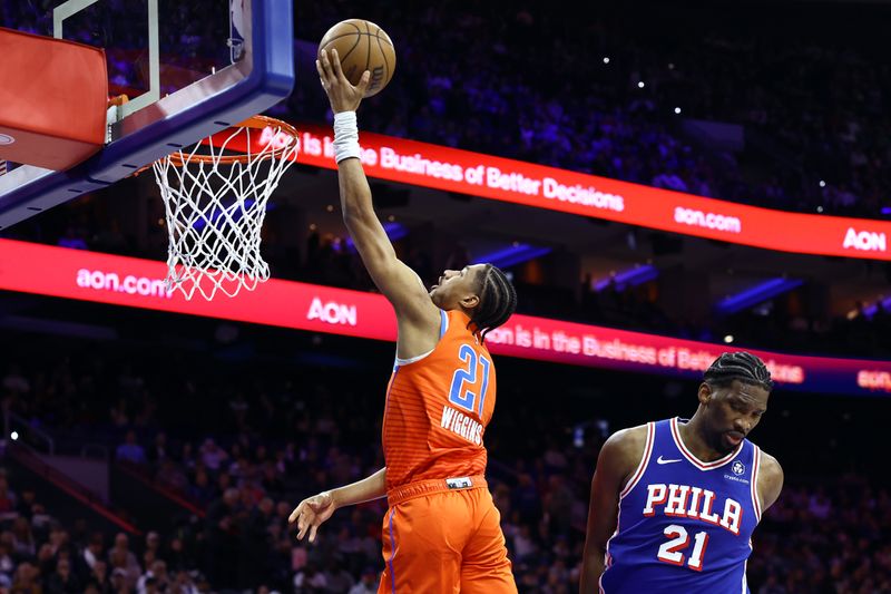 PHILADELPHIA, PENNSYLVANIA - APRIL 02: Aaron Wiggins #21 of the Oklahoma City Thunder shoots a lay up past Joel Embiid #21 of the Philadelphia 76ers during the first quarter at the Wells Fargo Center on April 02, 2024 in Philadelphia, Pennsylvania. NOTE TO USER: User expressly acknowledges and agrees that, by downloading and or using this photograph, User is consenting to the terms and conditions of the Getty Images License Agreement. (Photo by Tim Nwachukwu/Getty Images)