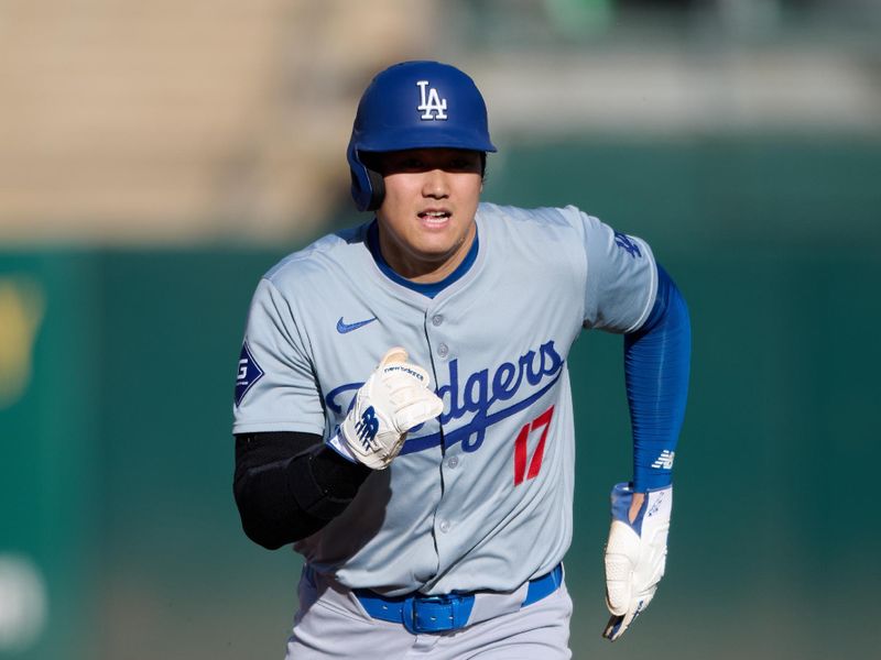 Aug 3, 2024; Oakland, California, USA; Los Angeles Dodgers designated hitter Shohei Ohtani (17) advances to third base on a sacrifice fly against the Oakland Athletics during the first inning at Oakland-Alameda County Coliseum. Mandatory Credit: Robert Edwards-USA TODAY Sports