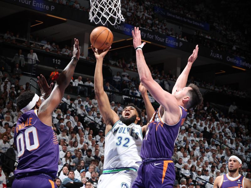 MINNEAPOLIS, MN -  APRIL 20: Karl-Anthony Towns #32 of the Minnesota Timberwolves drives to the basket during the game against the Phoenix Suns during Round 1 Game 1 of the 2024 NBA Playoffs on April 20, 2024 at Target Center in Minneapolis, Minnesota. NOTE TO USER: User expressly acknowledges and agrees that, by downloading and or using this Photograph, user is consenting to the terms and conditions of the Getty Images License Agreement. Mandatory Copyright Notice: Copyright 2024 NBAE (Photo by David Sherman/NBAE via Getty Images)