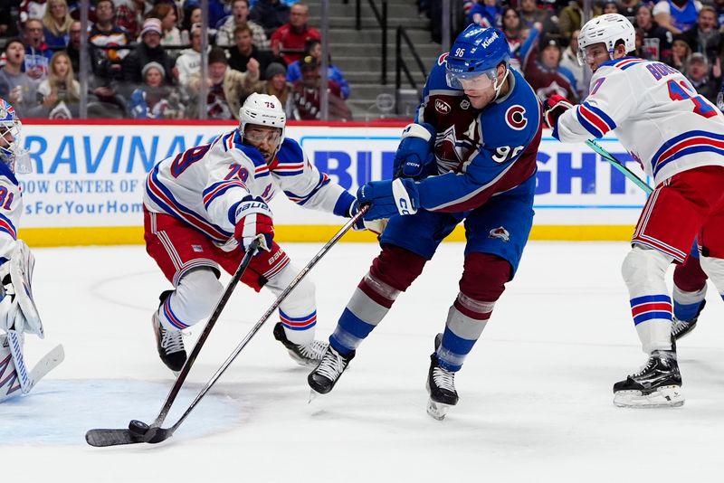 Jan 14, 2025; Denver, Colorado, USA; New York Rangers defenseman K'Andre Miller (79) defends on Colorado Avalanche right wing Mikko Rantanen (96) in the second period at Ball Arena. Mandatory Credit: Ron Chenoy-Imagn Images