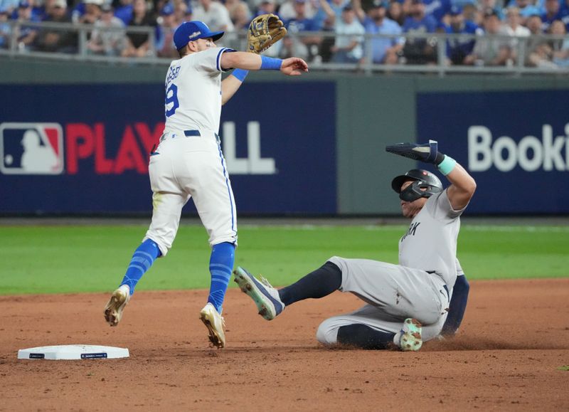 Oct 10, 2024; Kansas City, Missouri, USA; Kansas City Royals second baseman Michael Massey (19) attempts to tag out New York Yankees outfielder Aaron Judge (99) on a steal attempt during the eighth inning during game four of the ALDS for the 2024 MLB Playoffs at Kauffman Stadium. Mandatory Credit: Denny Medley-Imagn Images