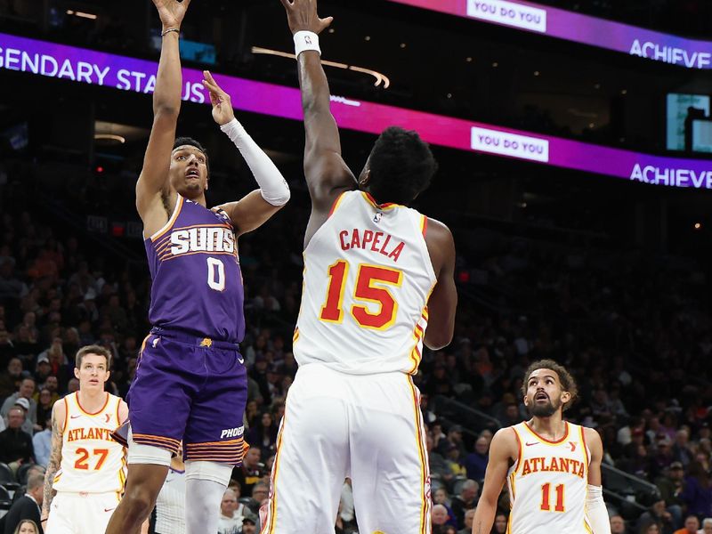 PHOENIX, ARIZONA - JANUARY 09: Ryan Dunn #0 of the Phoenix Suns puts up a shot over Clint Capela #15 of the Atlanta Hawks during the first half of the NBA game at Footprint Center on January 09, 2025 in Phoenix, Arizona. NOTE TO USER: User expressly acknowledges and agrees that, by downloading and or using this photograph, User is consenting to the terms and conditions of the Getty Images License Agreement.  (Photo by Christian Petersen/Getty Images)