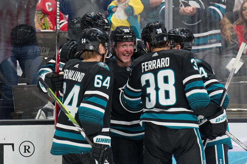 Mar 23, 2024; San Jose, California, USA; San Jose Sharks left wing Fabian Zetterlund (20) celebrates with his teammates after scoring a goal against the Chicago Blackhawks during the second period at SAP Center at San Jose. Mandatory Credit: Robert Edwards-USA TODAY Sports